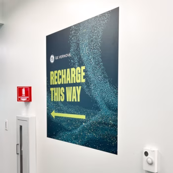 Greenville, SC wall mural showcasing GE Vernova's new branding while directing employees to the break room.