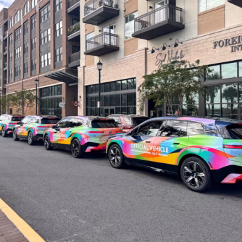 Colorful, rainbow patterned vehicle wrap for a line of marathon pace cars.