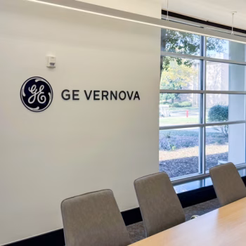 Black acrylic dimensional logo in a large conference room at GE Vernova in Greenville, SC.