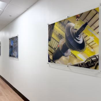 Acrylic displays showcasing GE Vernova product lines down a hallway in the customer center in Greenville, SC.