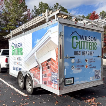 Full trailer warp showcasing Wilson Gutters' services and contact info with an image of a finished project in the background.