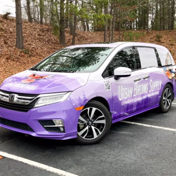Full coverage custom van wrap with purple mountains and birds in flight for Urban Birding Supply in Greenville, SC.