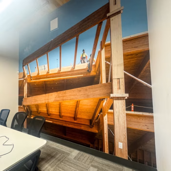 Large floor to ceiling wall mural in Timberlab's conference room depicting one of their recent work sites.