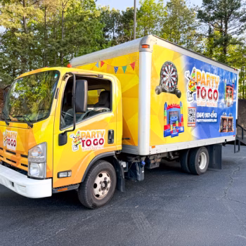 Large box truck completely wrapped with Party to Go's branding and classic bright colors.