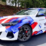 Custom full wrap on BMW with a paintstroke pattern on a white background for a lead car in a veterans race.
