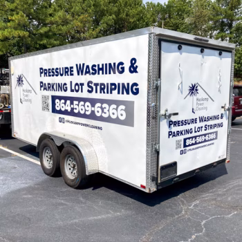 Blue and grey logo spot graphics on trailer for Huskamp.