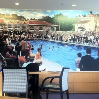 Wall mural of many people and a pool