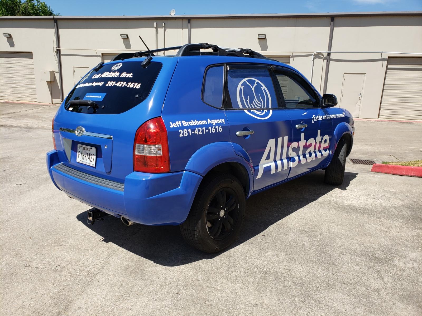 blue suv with the word allstate and contact info painted onto the car