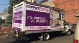 Cabinets To Go box truck parked in driveway advertising kitchen designs.