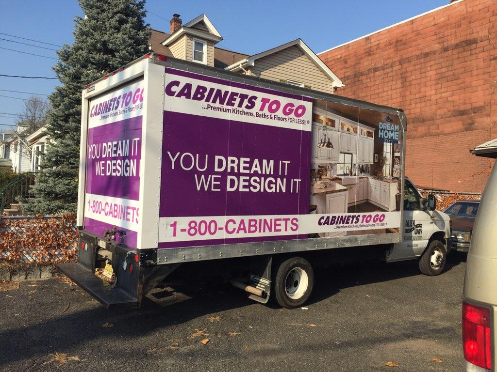 Cabinets To Go box truck parked in driveway advertising kitchen designs.