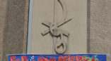 Colorful banner promoting a pan-American fair displayed on a building side