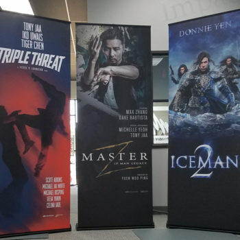 three pop up banners advertising movies