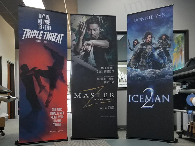 three pop up banners advertising movies