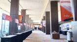 Event pole-banners displayed on flooring, ceiling visible at Omni Hotel Dallas.