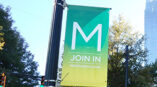 Vibrant outdoor advertising pole banner in urban setting