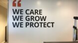 Inspirational wall mural with bold font in office