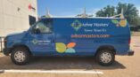 Side of full van vinyl car wrap with graphics and company logo