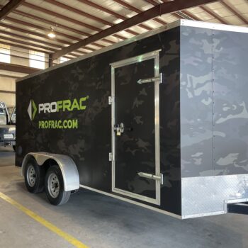 Front side of a trailer with black panel car wrap with company logo and camo graphics.