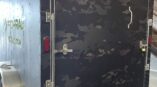 Camouflage graphic trailer wrap with logo on black background.