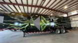 Side of a 54 foot data trailer with black panel car wrap with company logo and green lightning graphics.