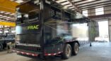 Back side of a 54 foot data trailer with black panel car wrap with company logo and green graphics.