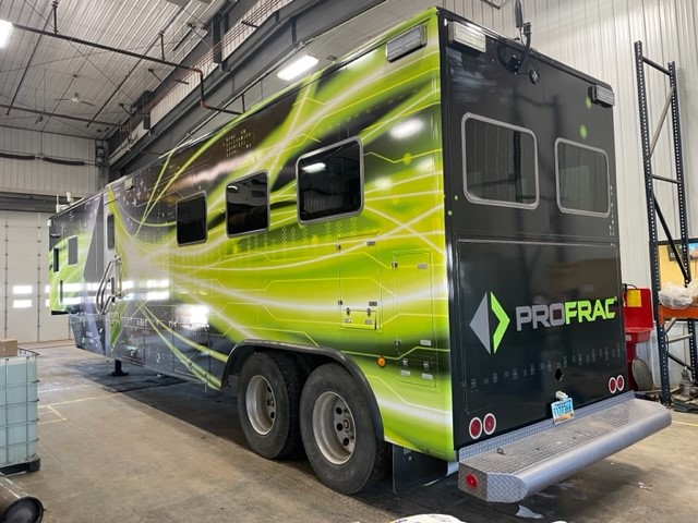 back side of a data trailer with a panel car wrap with company logo and green graphics.