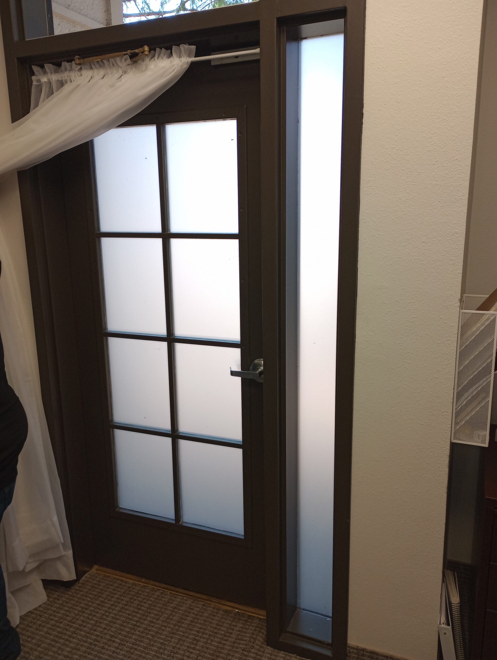 Elegant wood flooring with frosted glass door enhancing natural light