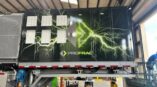 Back side of a data trailer with a panel car wrap with green lightning and company logo