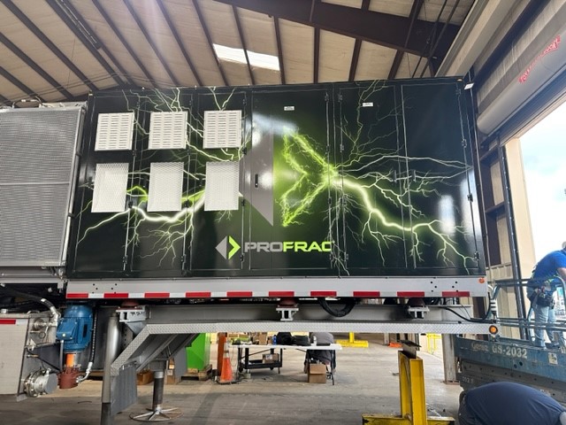 Back side of a data trailer with a panel car wrap with green lightning and company logo