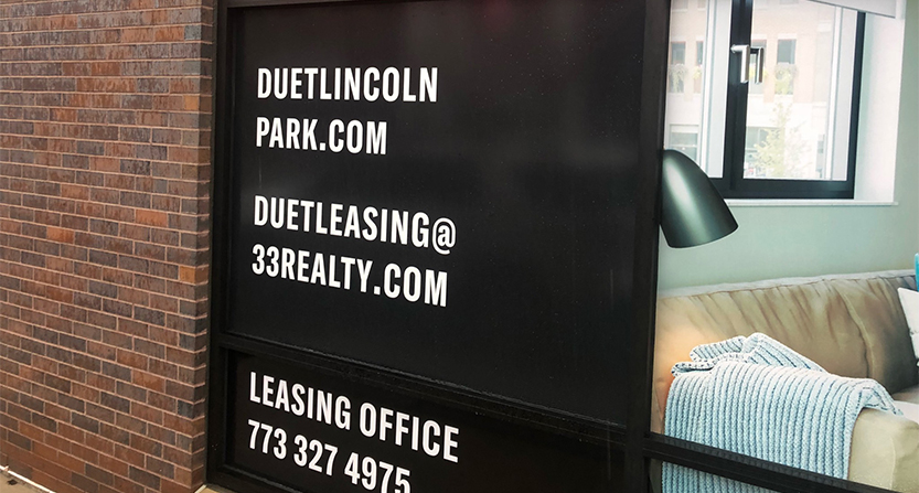 Window graphic advertisement for Duet Leasing in Lincoln Park