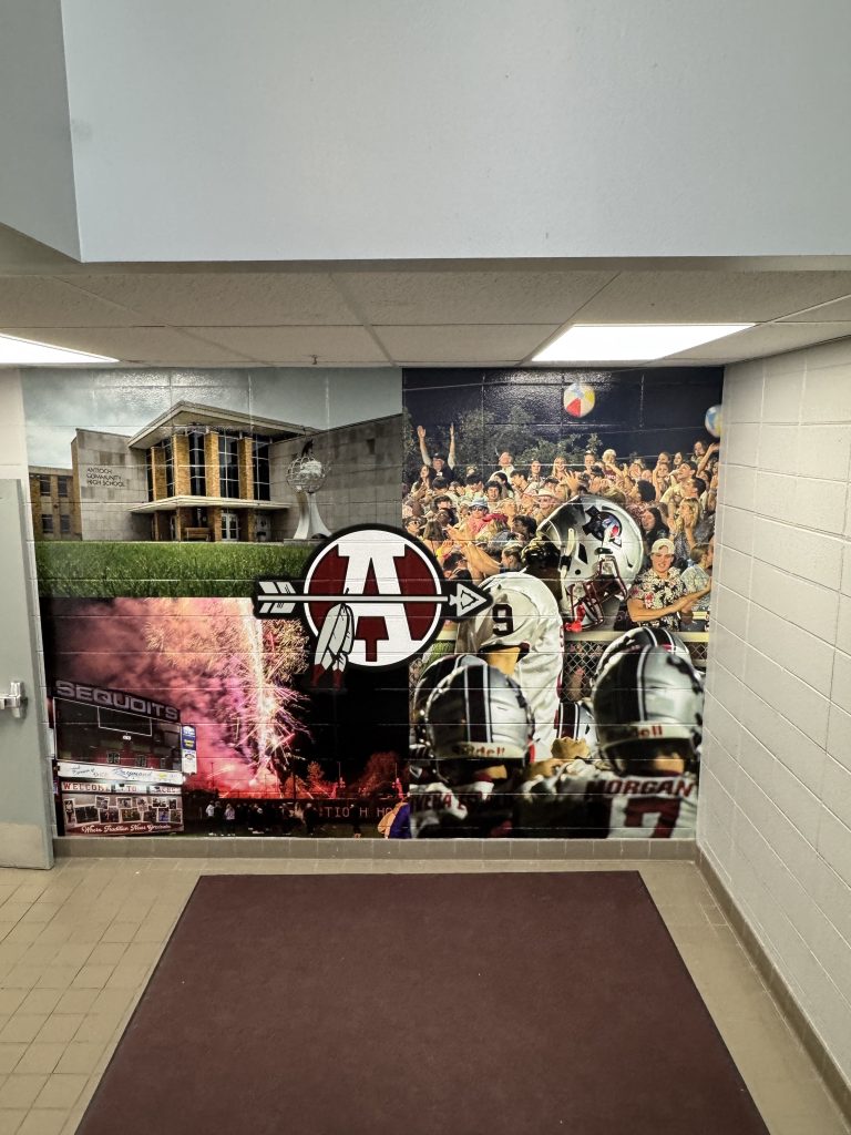 Large wall mural collage with school and football images printed on brick in Chicago, IL.