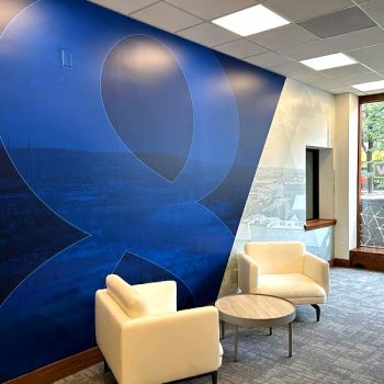 Large wall mural with blue and gray geometric design in an office in Chicago, IL.