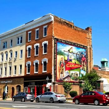 Large colorful wall mural painted on brick building exterior in Chicago, IL.