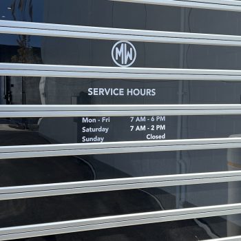 White vinyl window graphics with text and logo on a glass surface in Chicago, IL.