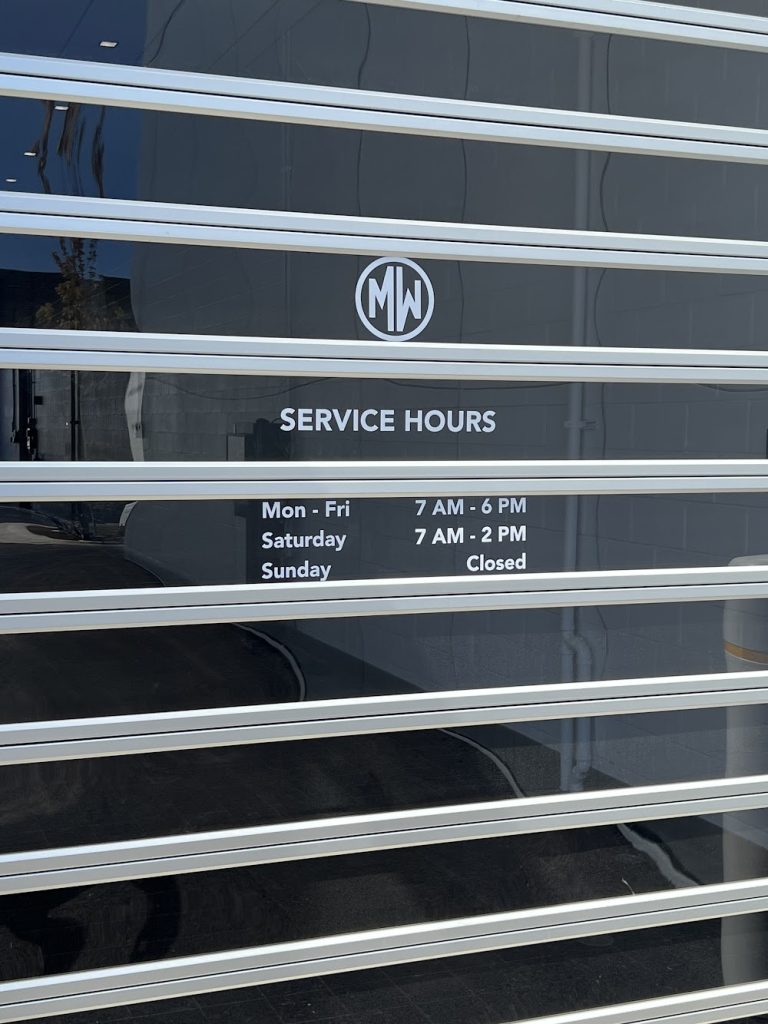 White vinyl window graphics with text and logo on a glass surface in Chicago, IL.