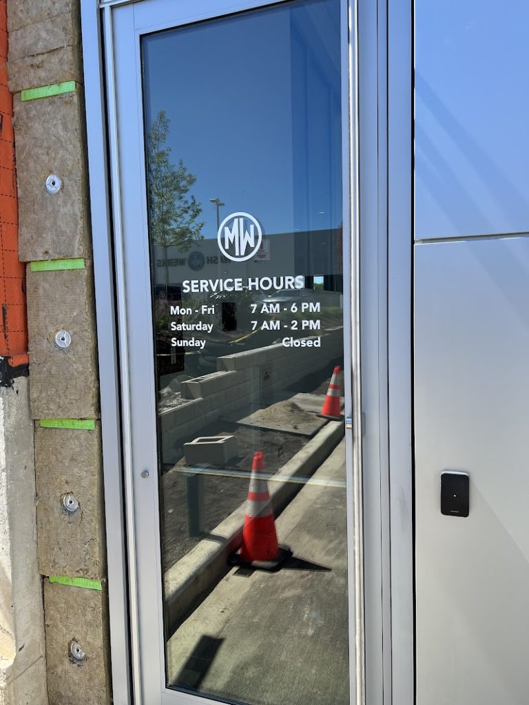 Clear vinyl window graphics with white text and logo on a glass door in Chicago, IL.