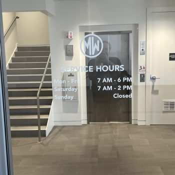 Frosted vinyl window graphics with logo and text in a building lobby in Chicago, IL.