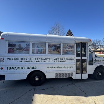 Partial vehicle wrap with child images and text on a white bus in Chicago, IL.