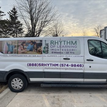 Partial vehicle wrap with photos and text graphics on a white van in Chicago, IL.