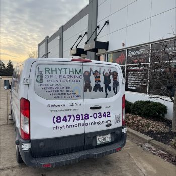 Partial vehicle wrap with children graphics and text on a white van in Chicago, IL.