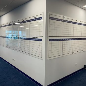 Large acrylic wall signs with grid layouts mounted on office walls in Chicago, IL.