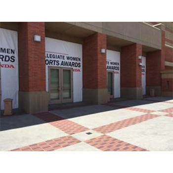Storefront with banners on the perimeters of doors for College Women Sports Award Honda 