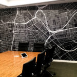 Black and white residential map wall graphic on office wall.