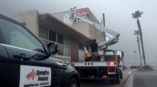 SpeedPro imaging attaching a new outdoor sign to a building