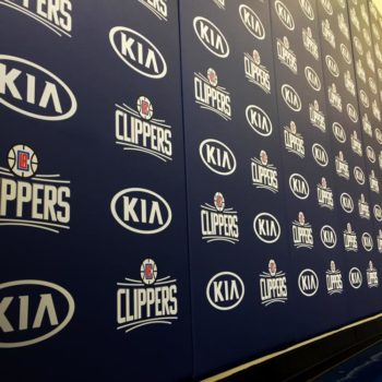 Indoor blue graphic with alternating logos for Kia and the Clippers