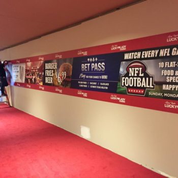 A wall mural for Lucky Lady Casino with advertisements for food and NFL football