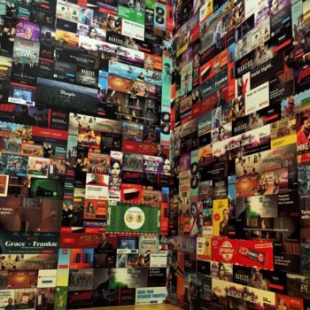 A large wall mural with many of Netflix original shows situated on it