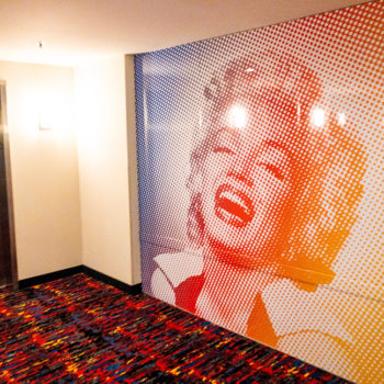 Wall mural of Marilyn Monroe on a wall next to an elevator