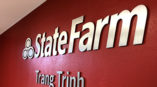 Indoor signs on a red wall for State Farm