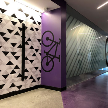 Black bike wall graphic on purple wall